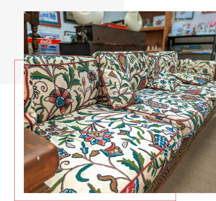 A couch with colorful floral pattern on it.