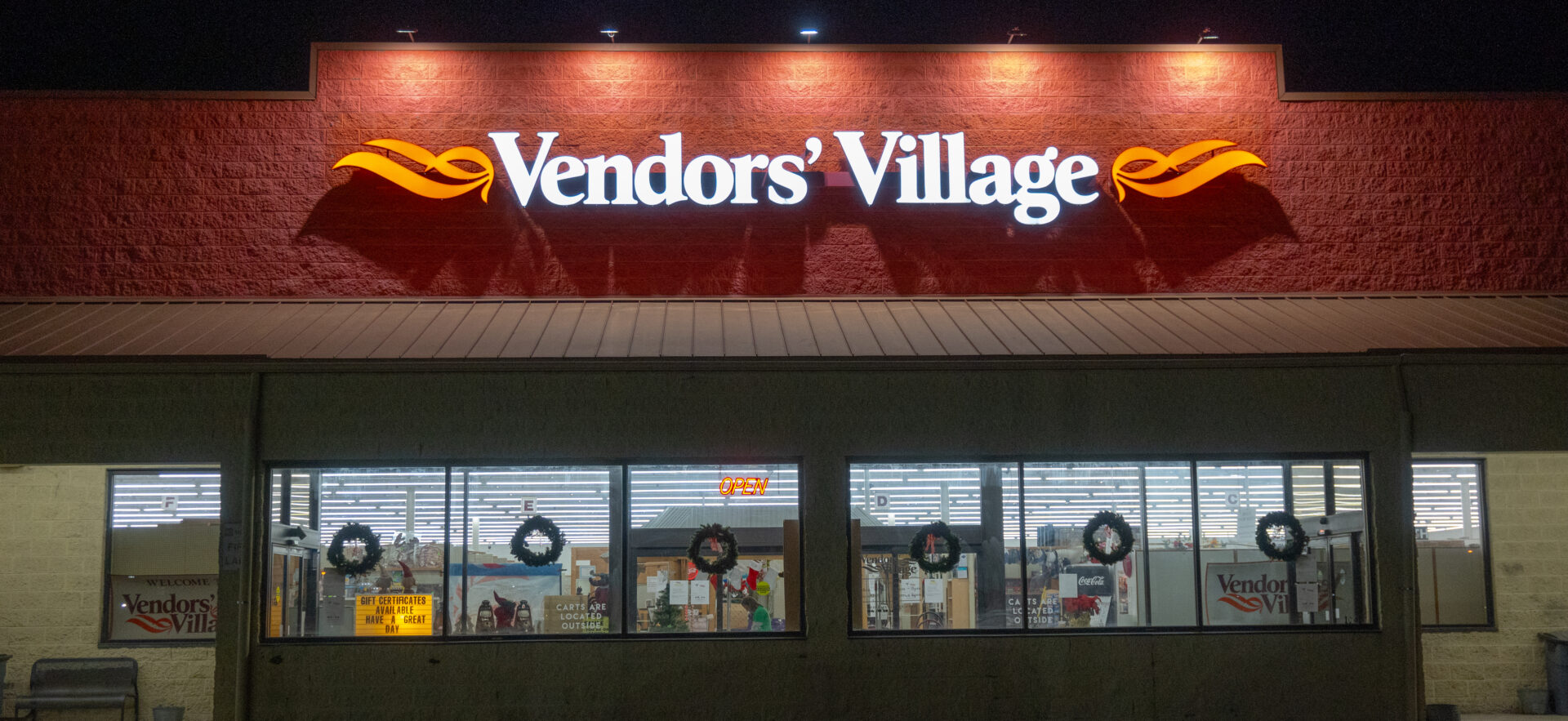 A store front with the words " vendors village ".